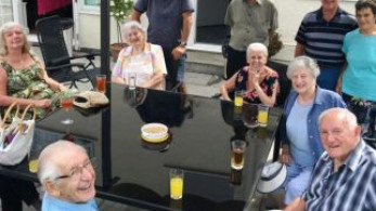 Two donkeys carry climbing gear through rough terrain with high snowy mountain peaks in the background.